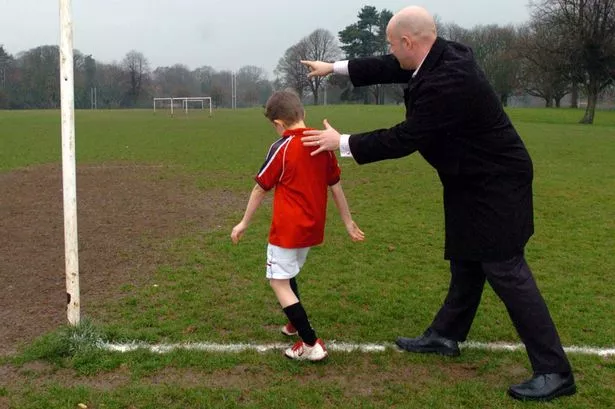 Pushy-father-encouraging-his-son-to-play-football